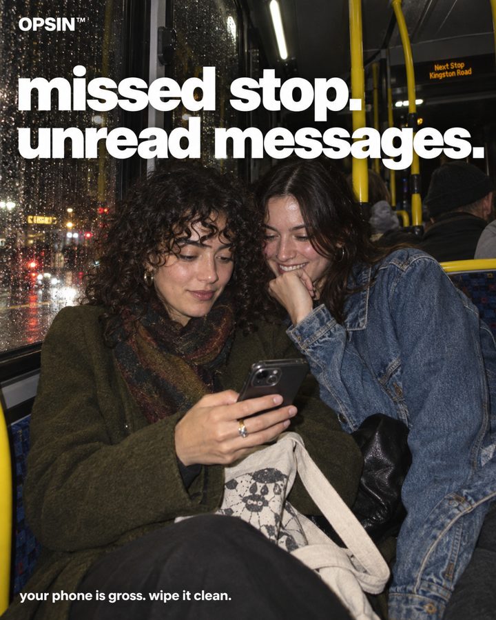Friends on a late bus looking at a phone