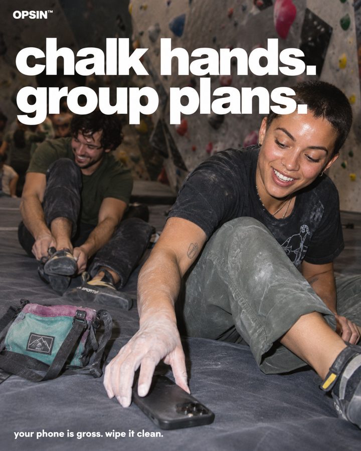 Climber reaching for a phone on a gym mat